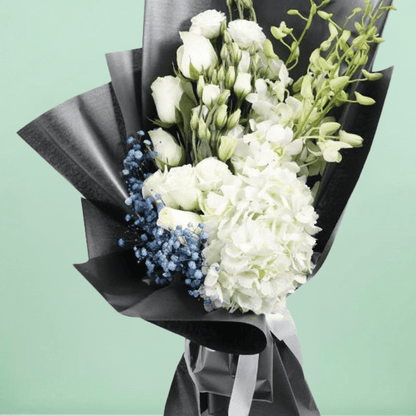 White hydrangea, Eustoma, orchids and roses with fillers wrapped in black non-woven paper