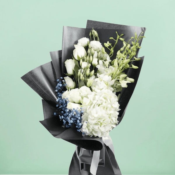 White hydrangea, Eustoma, orchids and roses with fillers wrapped in black non-woven paper