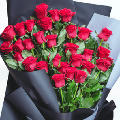A bouquet of 30 red roses wrapped in layered black and grey non-woven paper