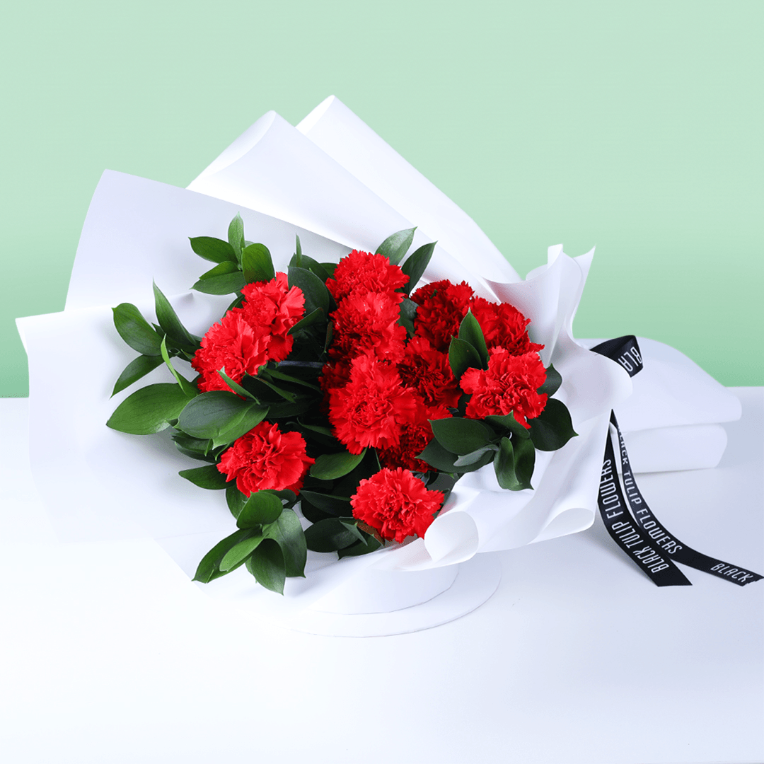 Crimson red carnation bouquet with fresh carnations and elegant wrapping