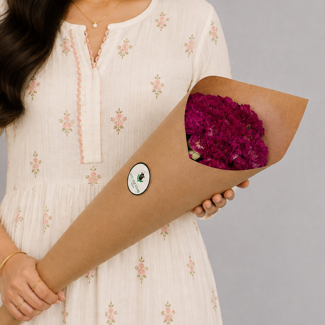 Fresh Carnation blooms neatly arranged in brown paper wrapping