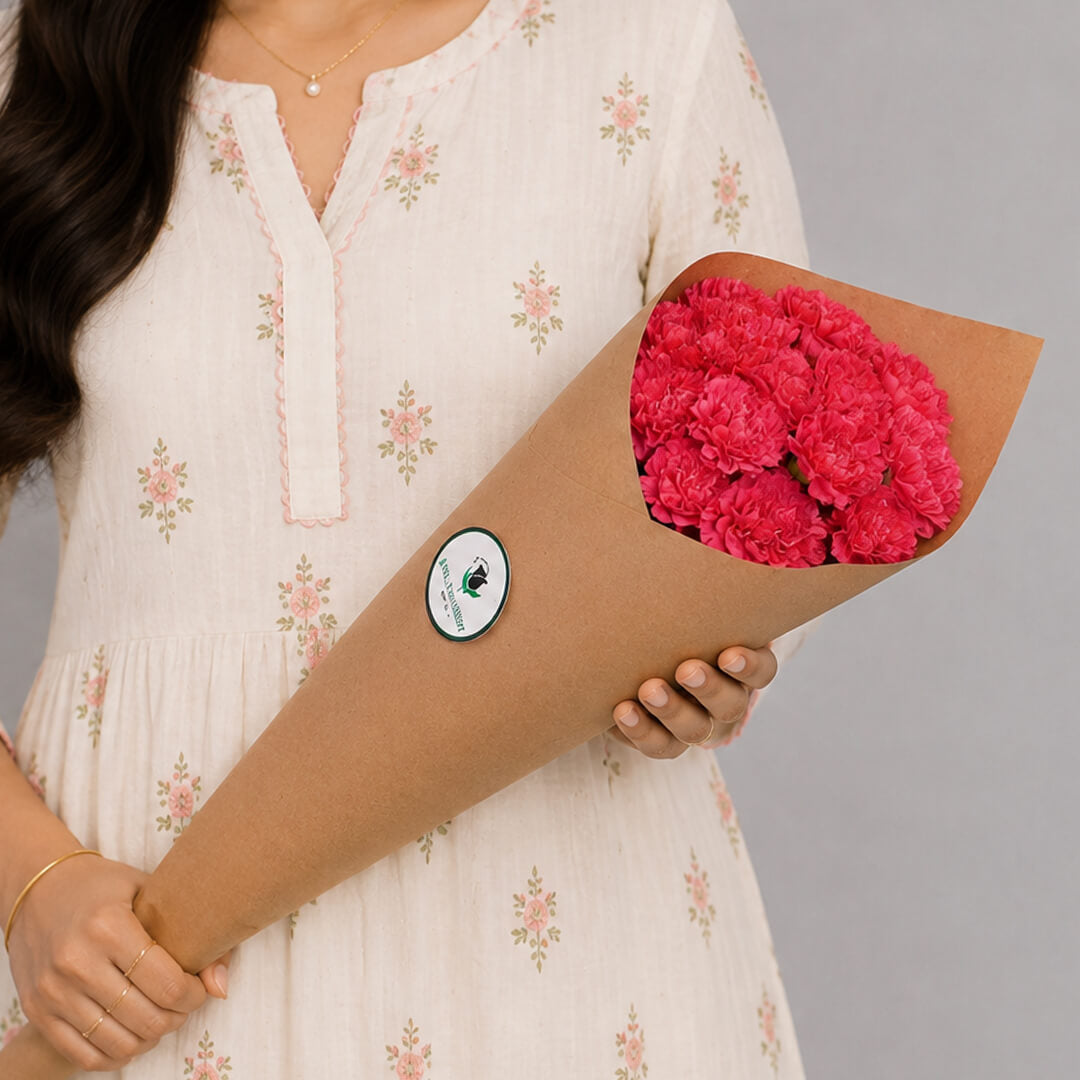 Fresh Carnation blooms neatly arranged in brown paper wrapping