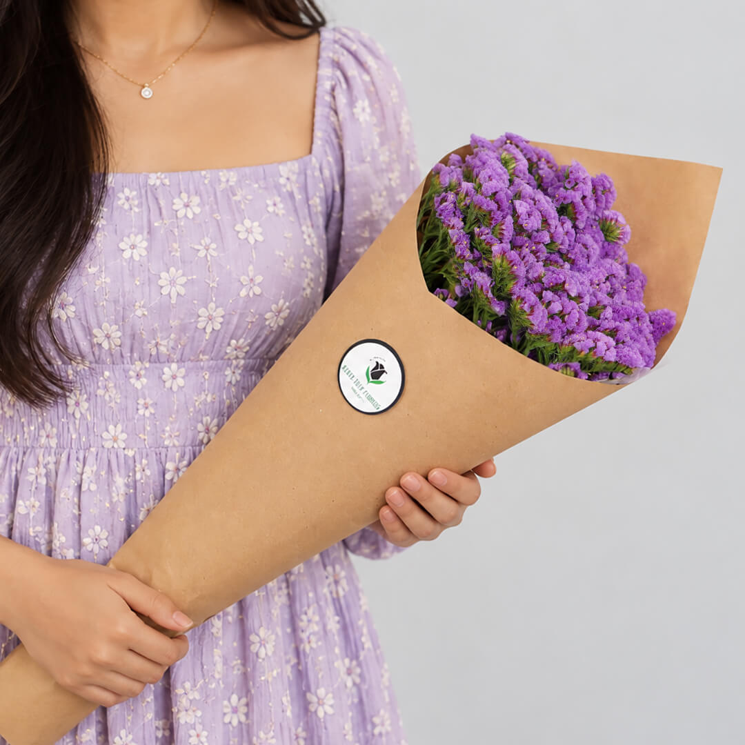 Statice blooms carefully arranged in brown paper wrapping
