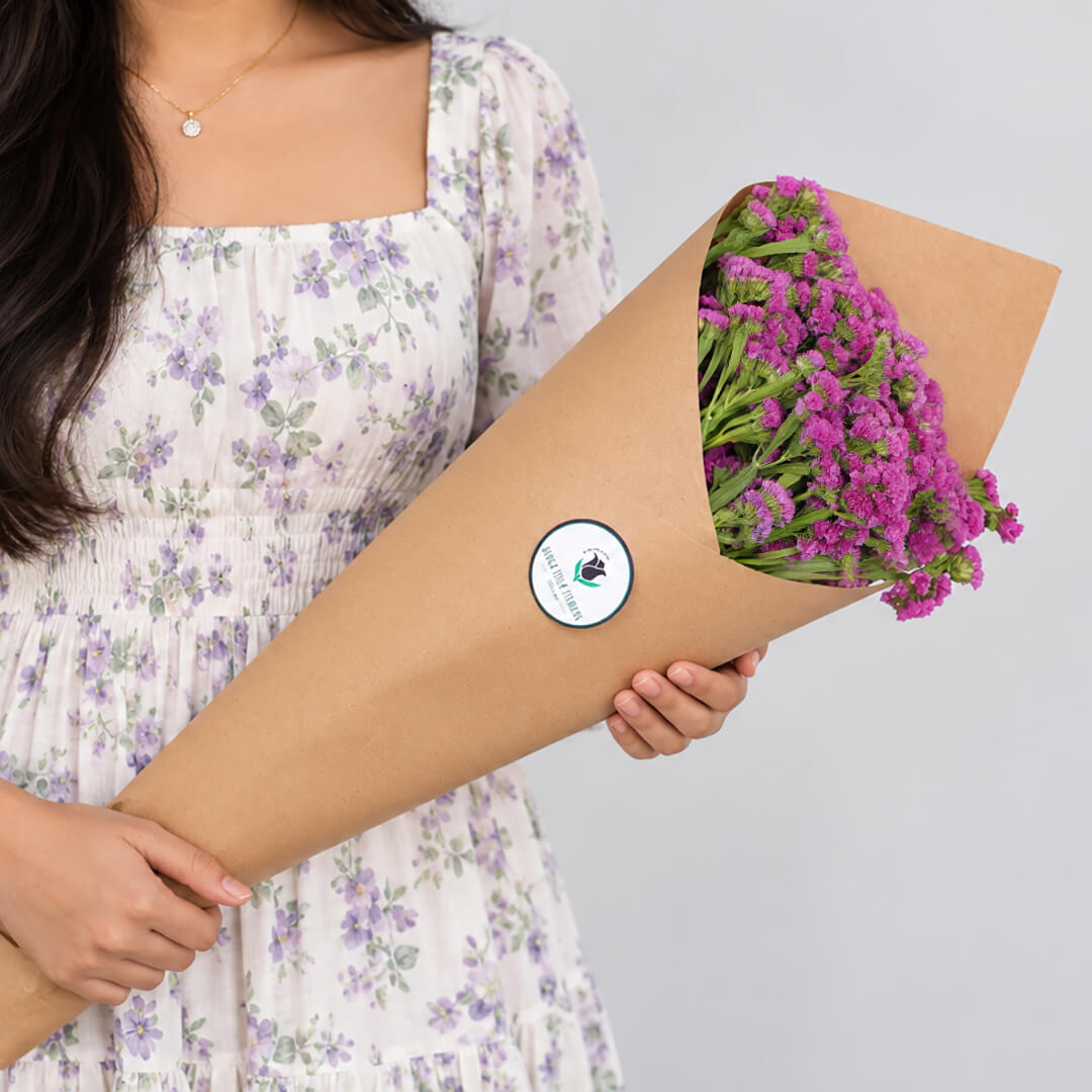 Statice blooms carefully arranged in brown paper wrapping