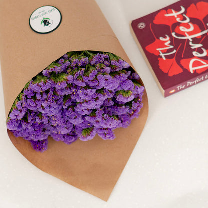 Statice blooms carefully arranged in brown paper wrapping
