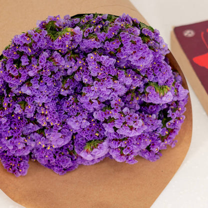 Statice blooms carefully arranged in brown paper wrapping