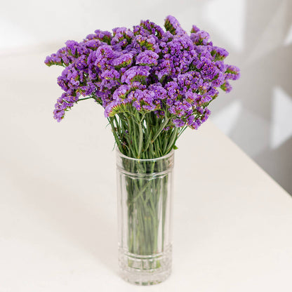 Statice blooms carefully arranged in brown paper wrapping