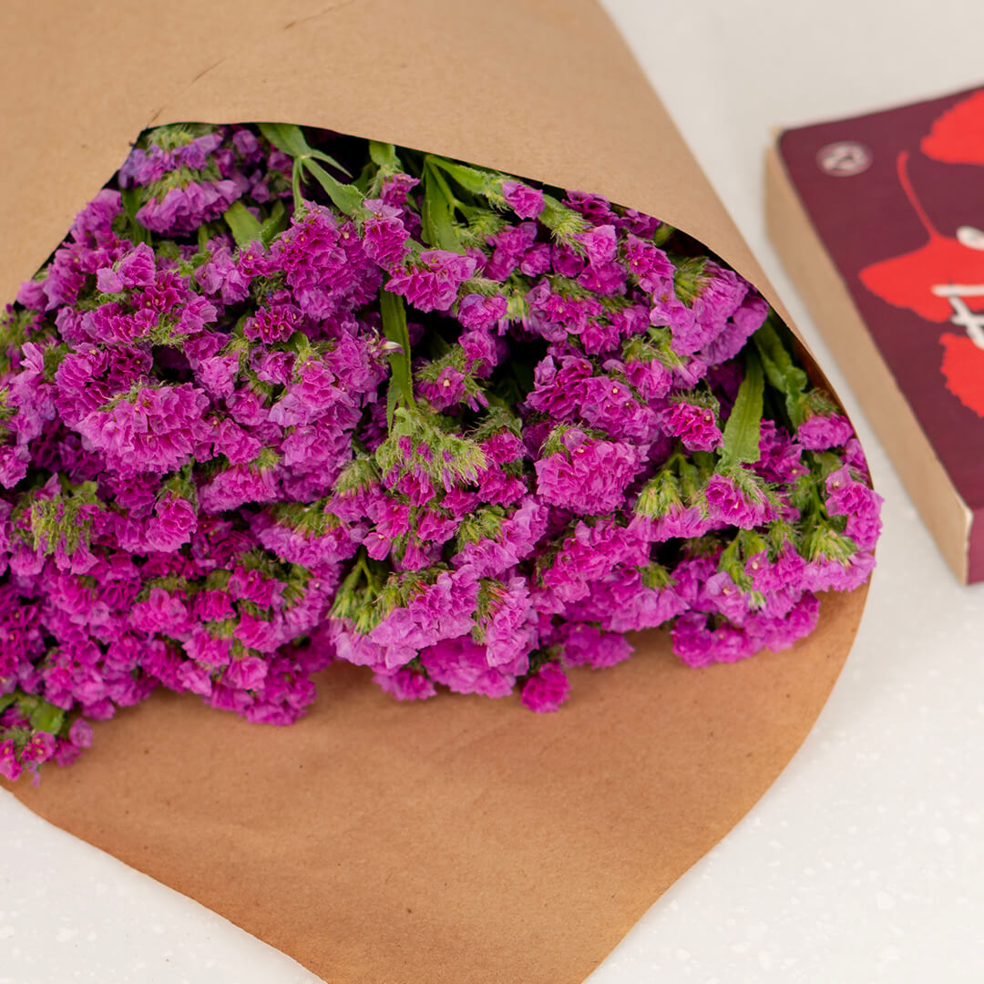 Statice blooms carefully arranged in brown paper wrapping