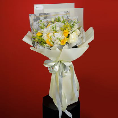 Bouquet featuring roses, Eustoma, golden rod and fillers in white non-woven wrapping, finished with elegant ribbons.