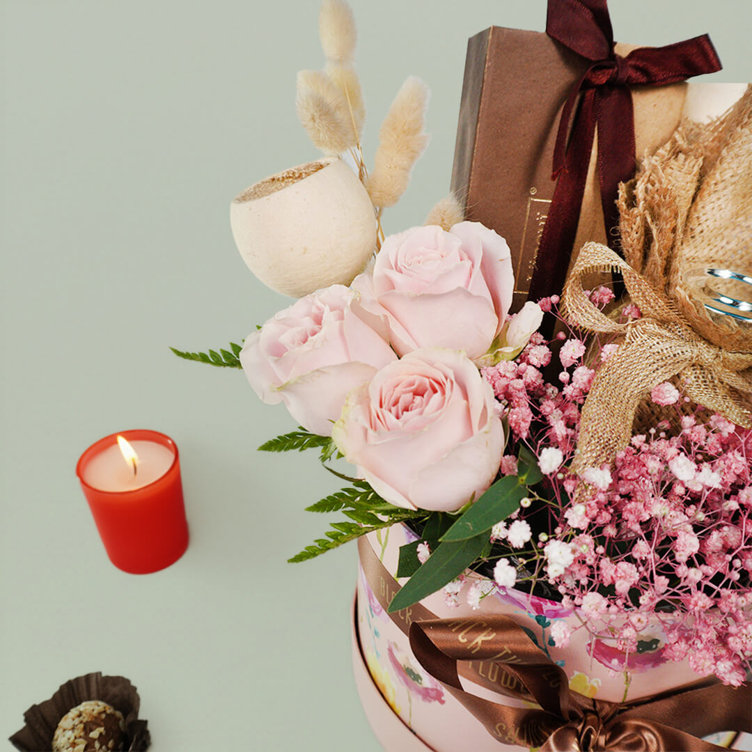 Diwali festive flower hamper with assorted roses carnations chocolates cashews and candle gift