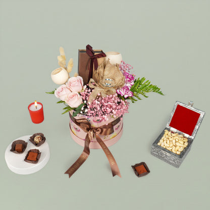 Diwali festive flower hamper with assorted roses carnations chocolates cashews and candle gift