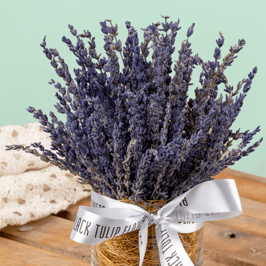 Dried lavender flowers arranged in a decorative cylindrical vase