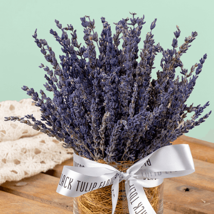 Dried lavender flowers arranged in a decorative cylindrical vase