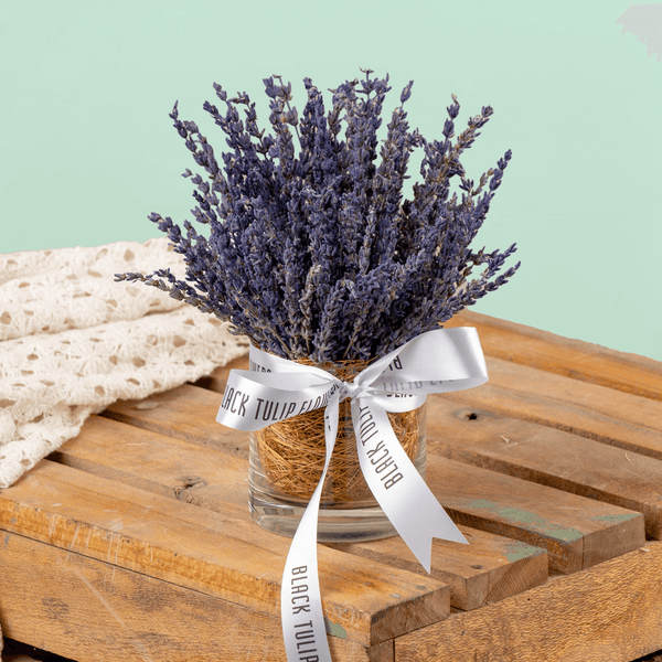 Dried lavender flowers arranged in a decorative cylindrical vase