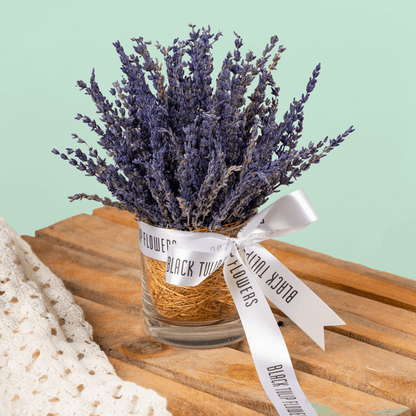 Dried lavender flowers arranged in a decorative cylindrical vase
