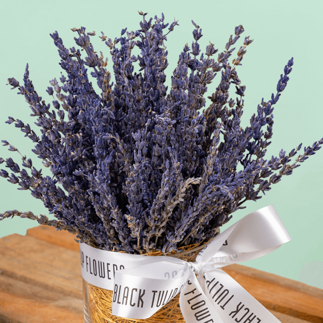 Dried lavender flowers arranged in a decorative cylindrical vase