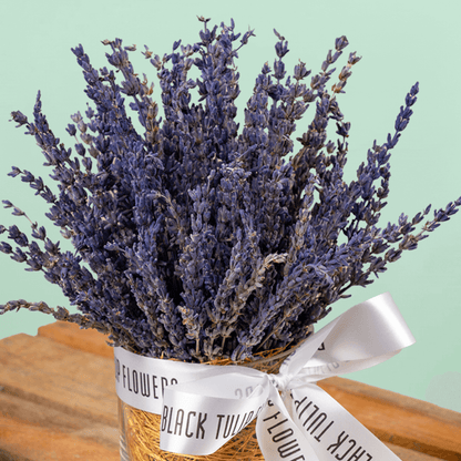 Dried lavender flowers arranged in a decorative cylindrical vase
