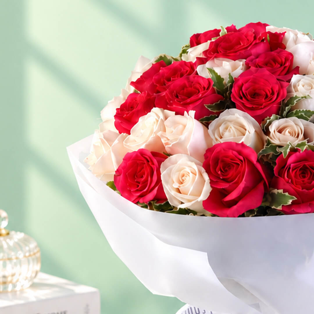 35 red and white roses in a neatly wrapped floral bouquet