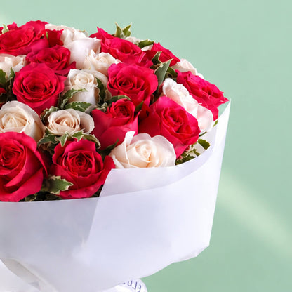 35 red and white roses in a neatly wrapped floral bouquet