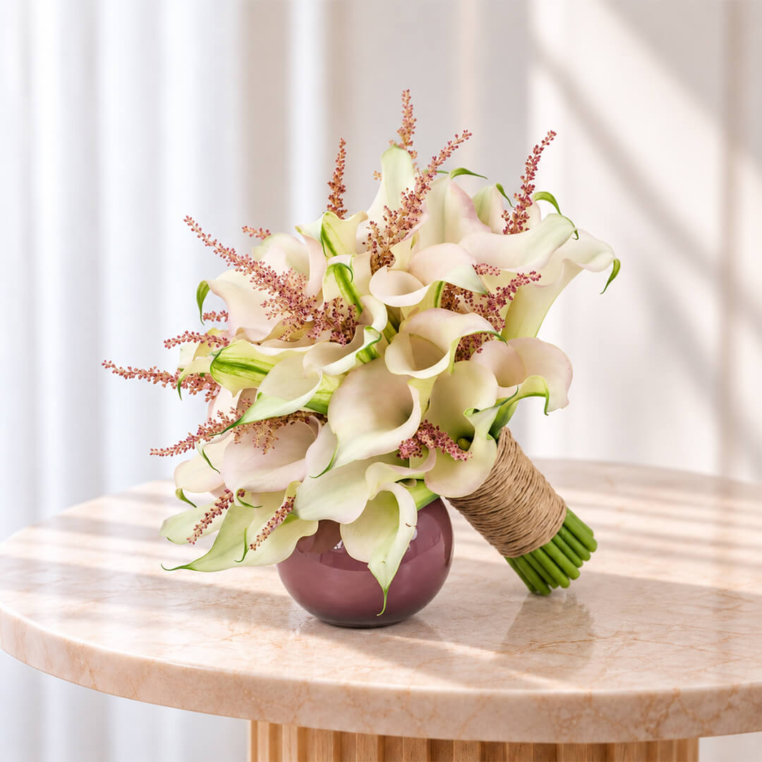 White Calla Lily and pink Astilbe bridal bouquet with two-tone blooms in a minimalist wrap