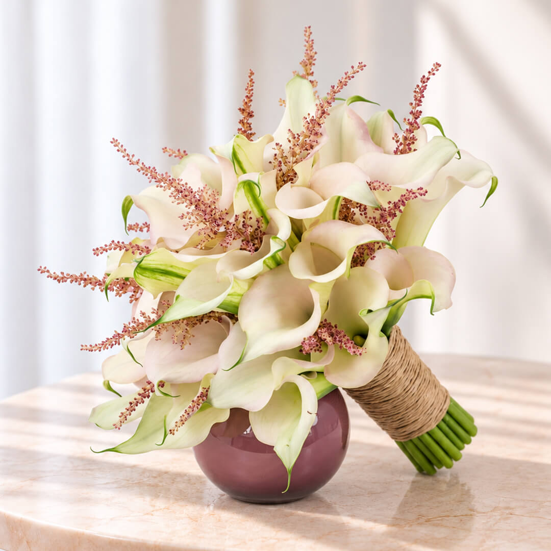 White Calla Lily and pink Astilbe bridal bouquet with two-tone blooms in a minimalist wrap