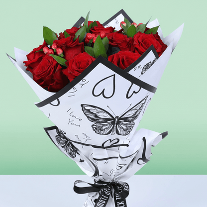 Red Romance Rose Bouquet arranged with red roses, berries and fresh fillers
