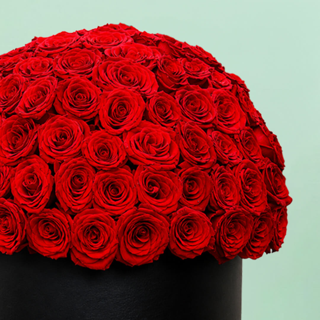 Grand red rose hat box featuring 55–60 romantic red roses in a full dome arrangement