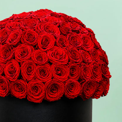 Grand red rose hat box featuring 55–60 romantic red roses in a full dome arrangement