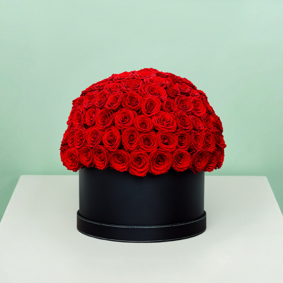 Grand red rose hat box featuring 55–60 romantic red roses in a full dome arrangement
