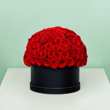 Grand red rose hat box featuring 55–60 romantic red roses in a full dome arrangement