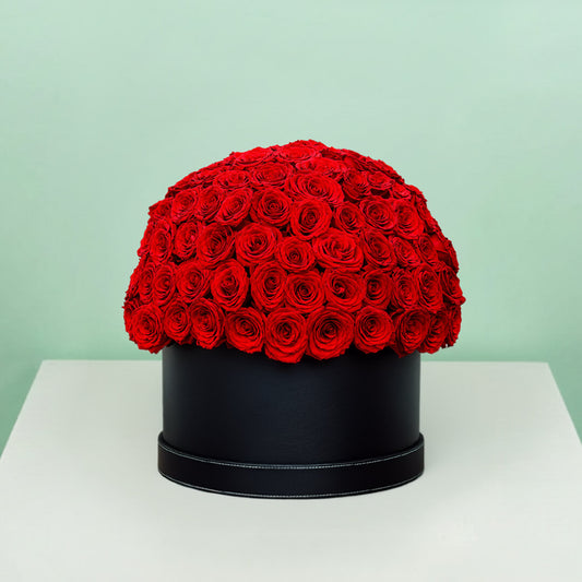 Grand red rose hat box featuring 55–60 romantic red roses in a full dome arrangement