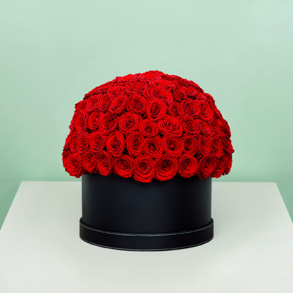 Grand red rose hat box featuring 55–60 romantic red roses in a full dome arrangement