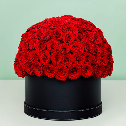 Grand red rose hat box featuring 55–60 romantic red roses in a full dome arrangement