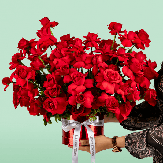 Classic red rose bloom box arranged in premium round red flower box