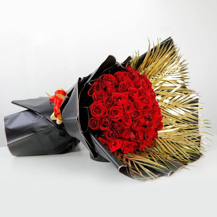 Grand bouquet of 70 red roses with gold palm leaves in black Korean-style wrapping