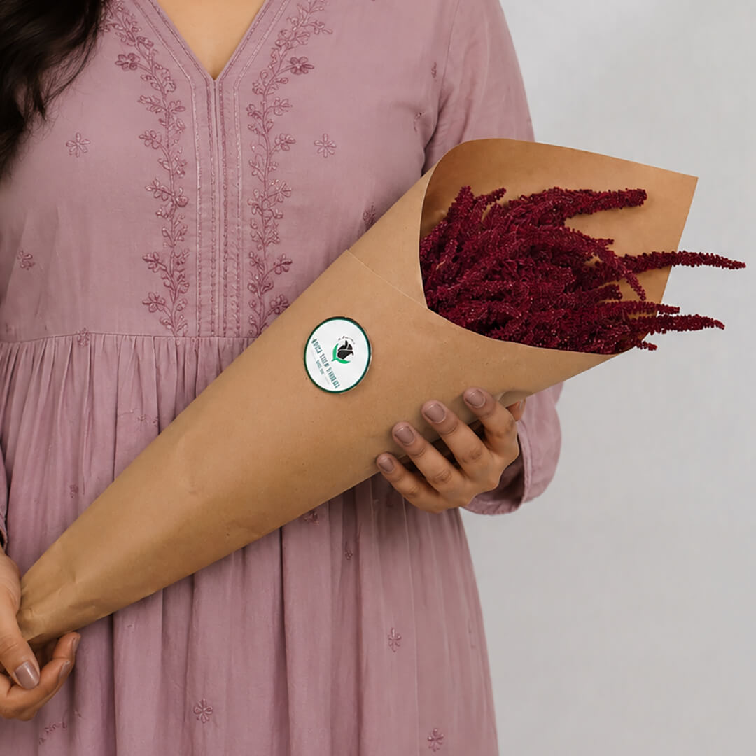 Hanging Amaranthus cut flowers in red colour wrapped in brown paper