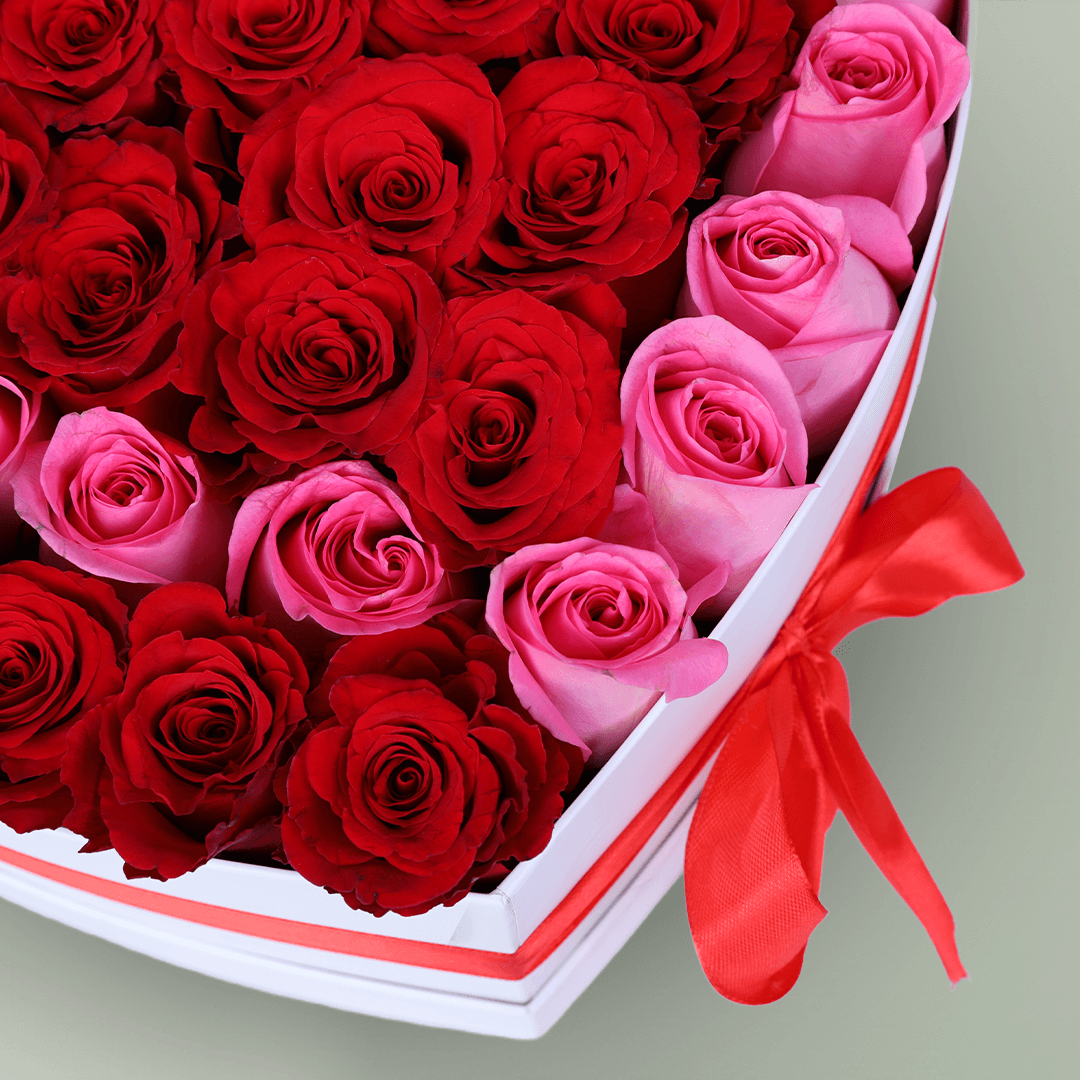 Love Bloom Rose Heart Box arranged with red and pink roses