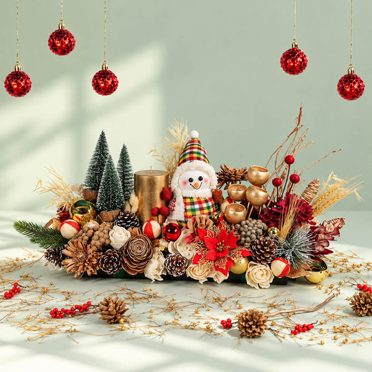 Joyful Hearth Christmas floral centerpiece with assorted dried flowers, pinecones, Craspedia, candle, and festive table runner
