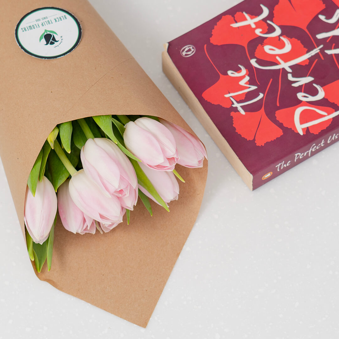 Fresh light pink cut tulip flowers in a bouquet with soft blush petals