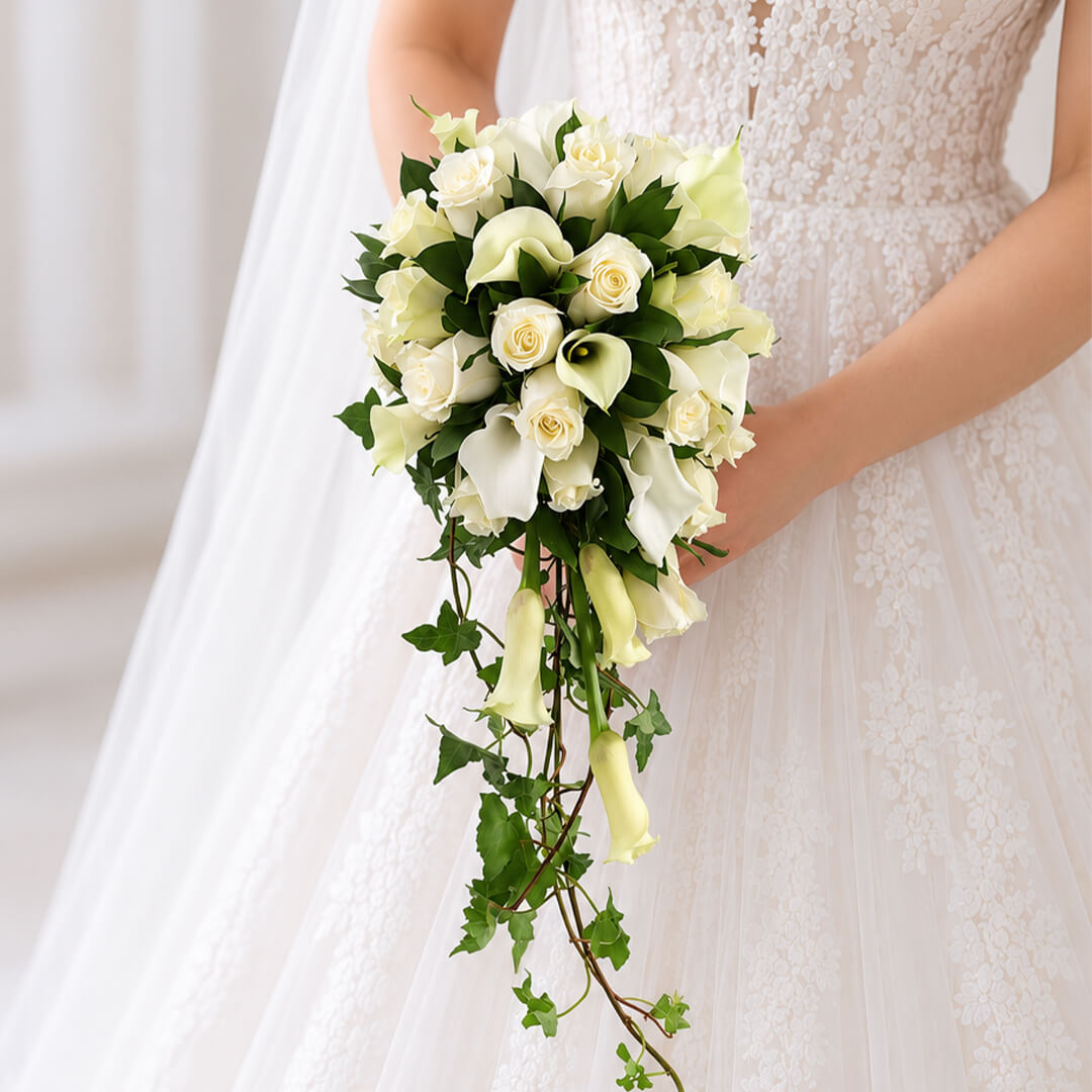 Elegant white Calla lily and rose bridal bouquet with lush greenery and minimalist wrap