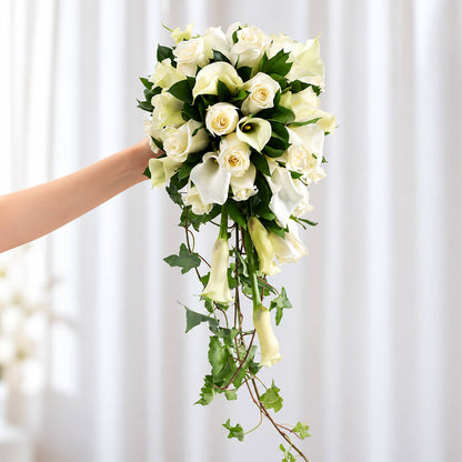 Elegant white Calla lily and rose bridal bouquet with lush greenery and minimalist wrap