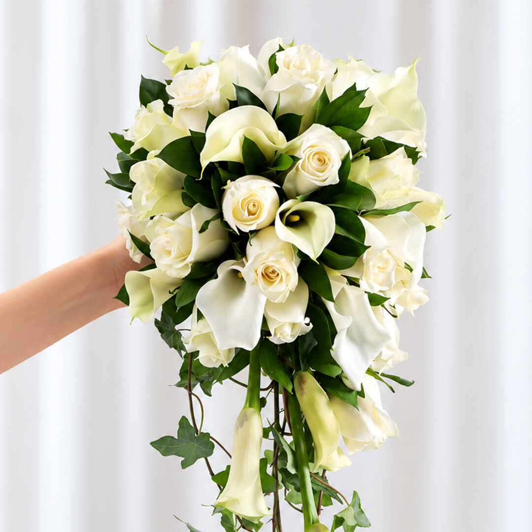 Elegant white Calla lily and rose bridal bouquet with lush greenery and minimalist wrap