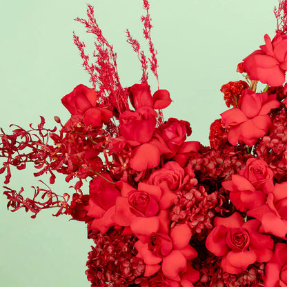 Red flower box with hydrangea, roses, orchids and dried flowers
