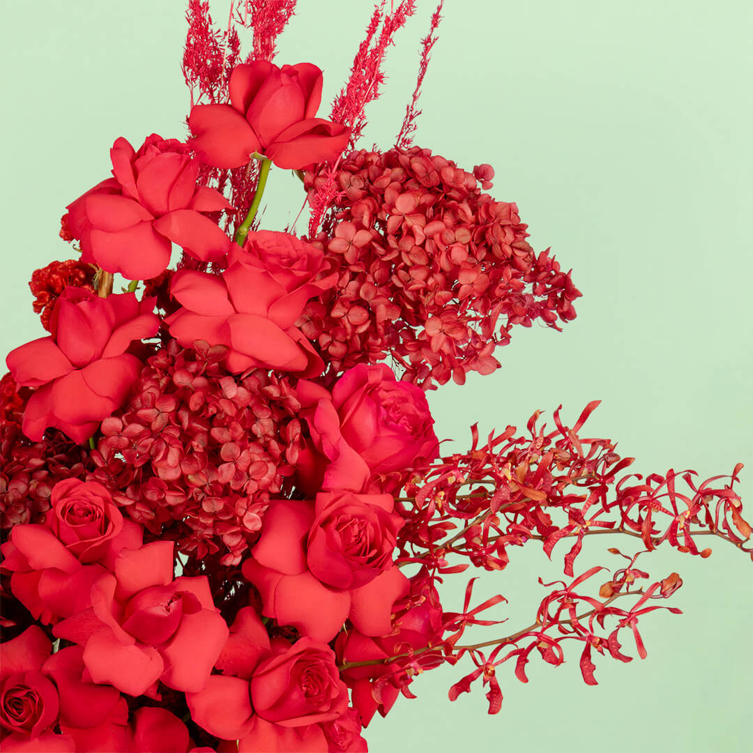 Red flower box with hydrangea, roses, orchids and dried flowers
