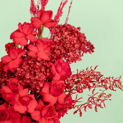 Red flower box with hydrangea, roses, orchids and dried flowers
