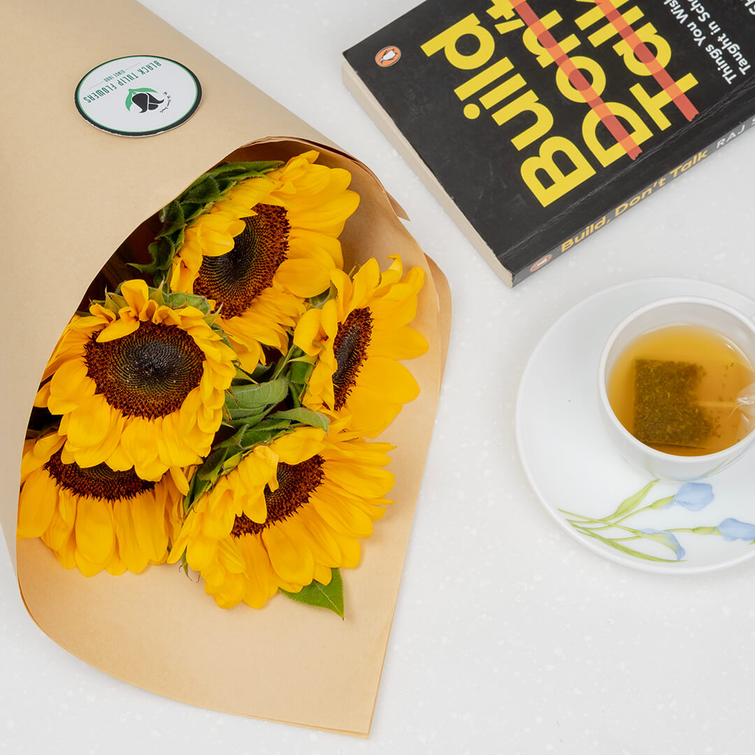 Premium cut sunflowers wrapped in a protective sleeve for fresh flower arrangements.