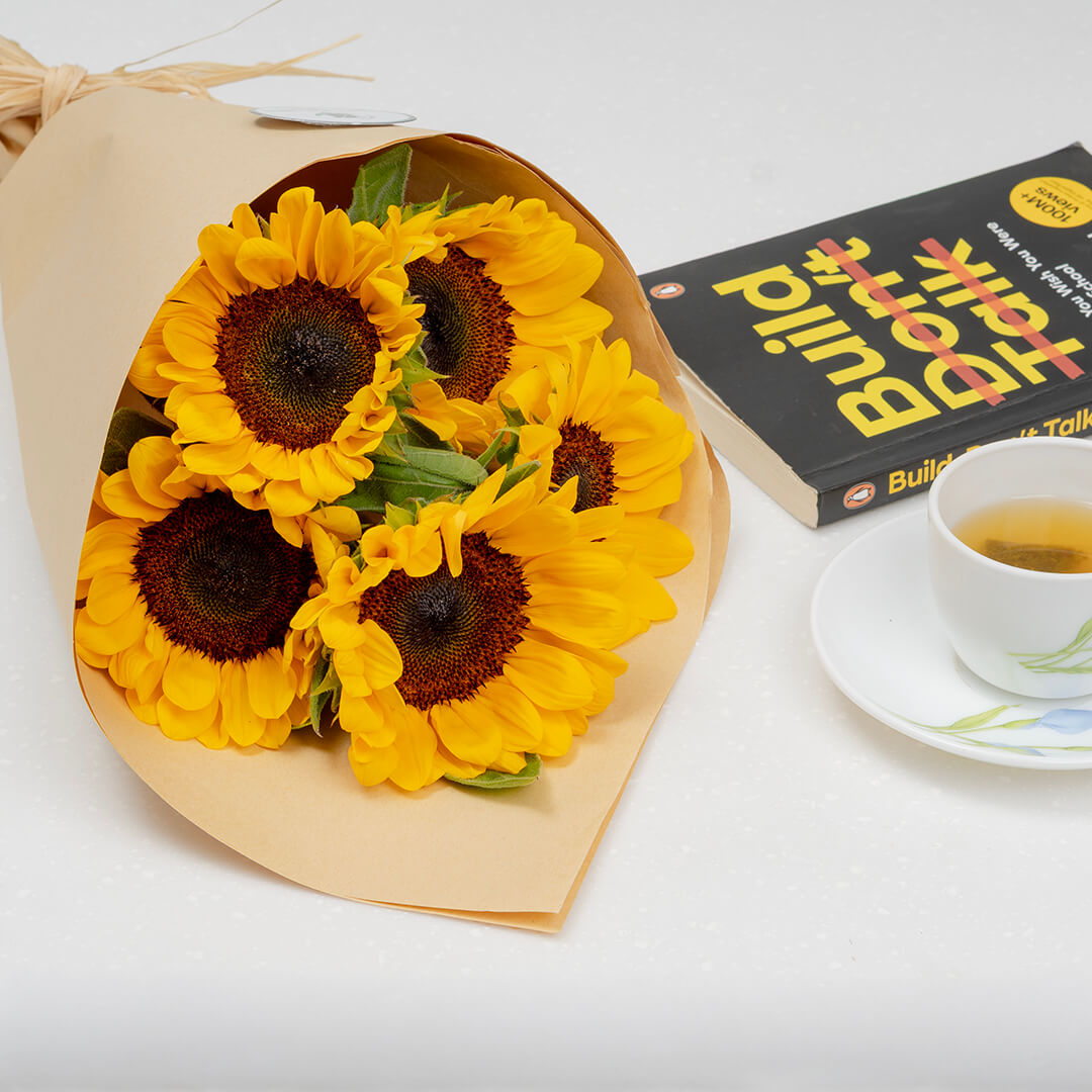 Premium cut sunflowers wrapped in a protective sleeve for fresh flower arrangements.