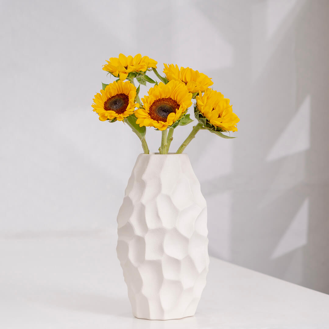 Premium cut sunflowers wrapped in a protective sleeve for fresh flower arrangements.