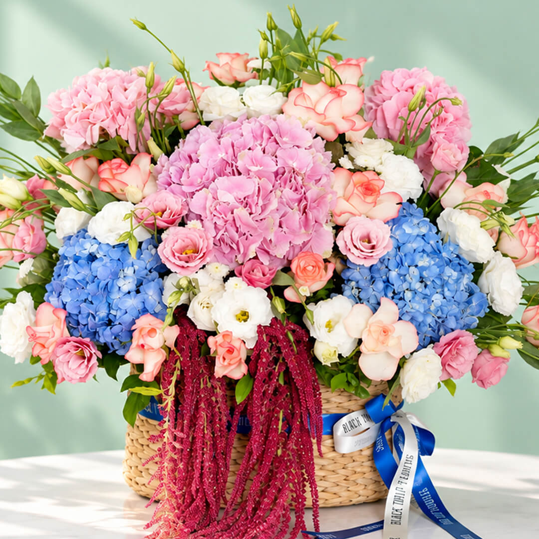 Mixed floral basket with hydrangea, roses, eustoma and amaranthus arranged in a rectangular basket