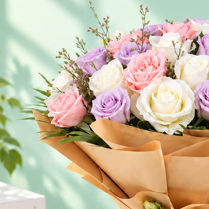Mixed-colour roses arranged in a bouquet with non-woven wrapping